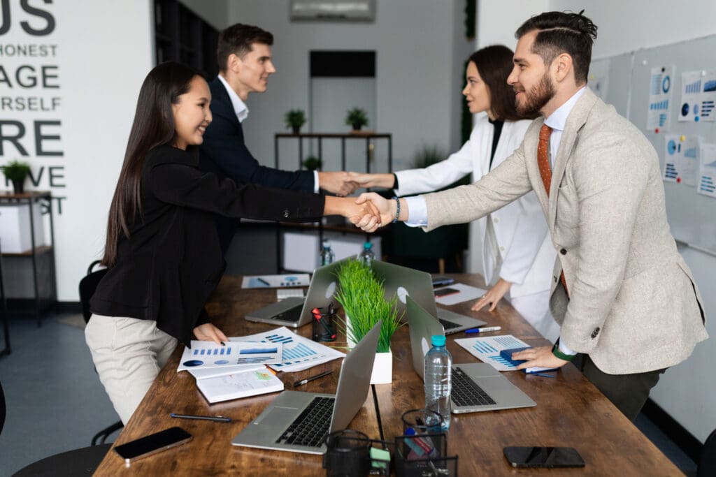 Four professional people shaking hands