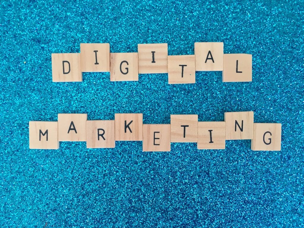 Digital marketing spelled out in wooden tiles on blue background. 