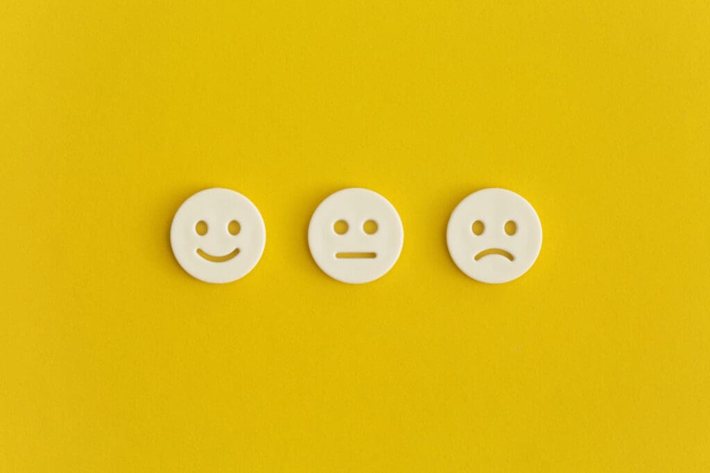 Emoticon smile on a yellow background. Customer feedback. Concept of online ratings