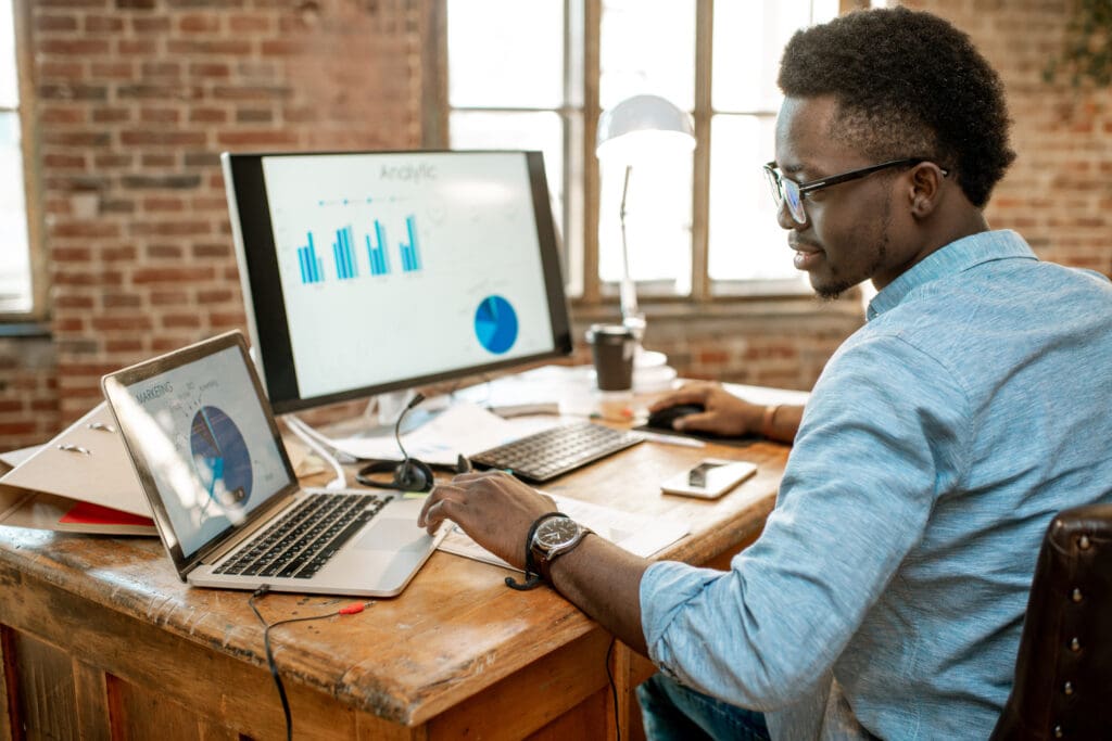 Young man measuring business success, analytics