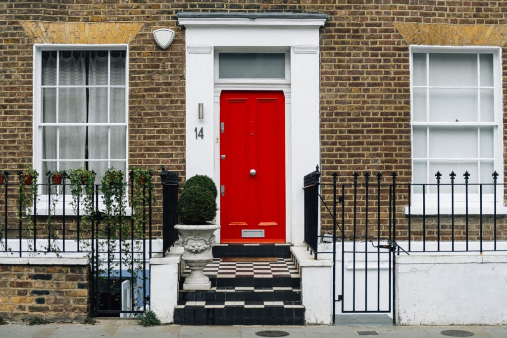 Home exterior.  Bright red front door with tiled steps.  Concept of curb appeal