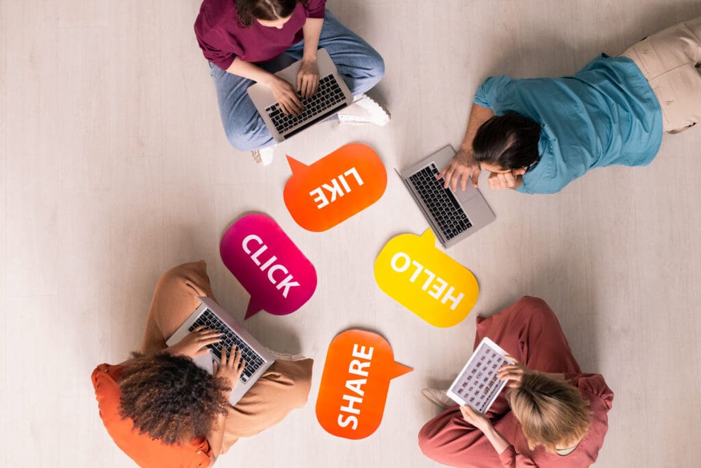 Social media advertising concept. Above view of young people sitting and lying on floor with social media 