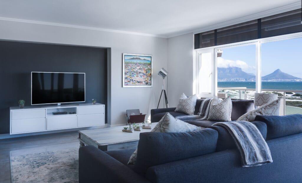 Stylish blue and gray living room with view