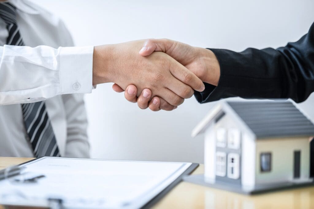 Real estate agent shaking hands after good deal 