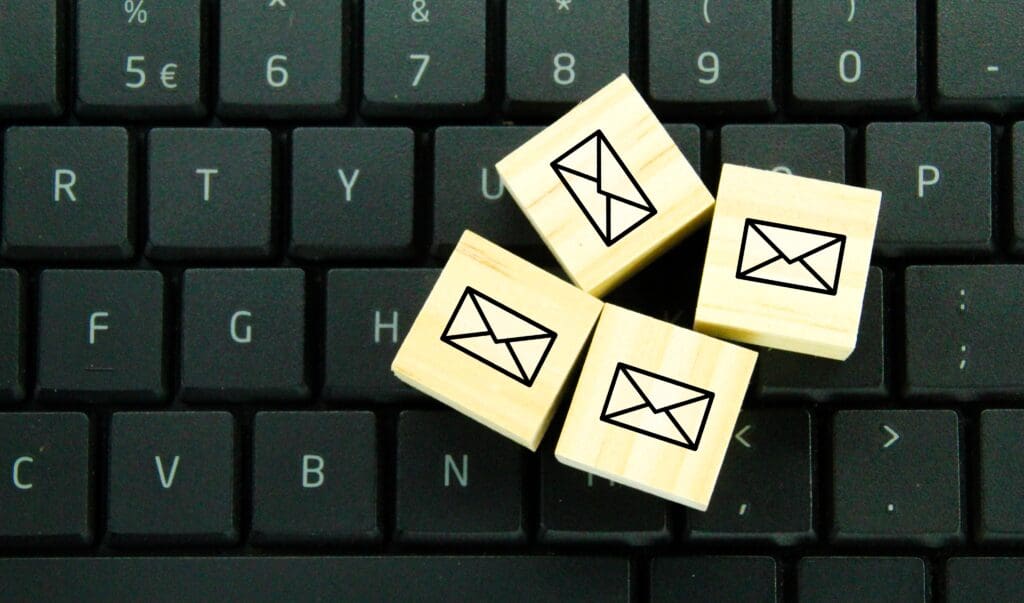 Computer keyboard and wooden blocks with email icon.  